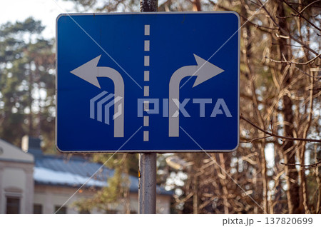 Road sign showing directions for left and right turns in a forest area Road sign showing directions for left and right turns in a forest area 137820699
