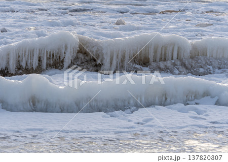 Ice formations on the shoreline during winter time in a cold coastal area Ice formations on the shoreline during winter time in a cold coastal area 137820807