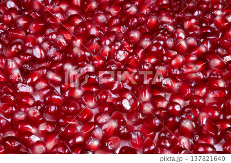 Bright pomegranate seeds bowl, superfood arranged for nutritionist concept, nutrientrich arils spilling with natural sheen, healthy snack and wellness imagery under studio lighting 137821640