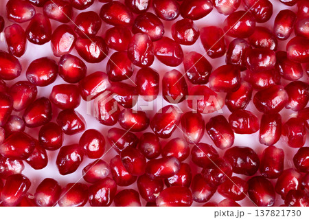 Bright colored seeds bursting flavor. Luminous crimson stones paired with lively taste. Brightly colored seeds with deliciously refreshing taste and vibrant visual appeal 137821730