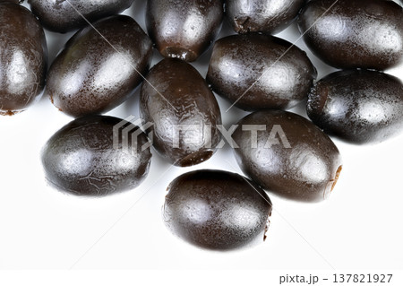 Arrangement of black olives designed for food photography in empty space. Black olives meticulously placed for culinary shot emphasizing bright white negative area Arrangement of black olives designed for food photography in empty space. Black olives meticulously placed for culinary shot emphasizing bright white negative area 137821927