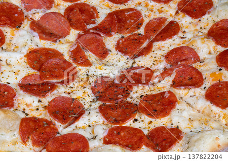Gourmet pizza presentation. Upscale pepperoni pizza display. Elegant pepperoni pizza with black pepper accents. Refined artisan pizza with cracked black pepper and glossy oil 137822204
