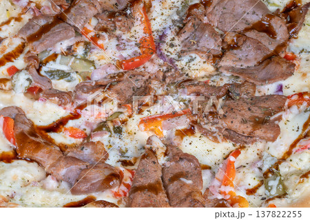 Gourmet fusion pizza. Colorful meat and cheese dish. Elegant flatbread with marinated toppings and herbs. Upscale fusion pizza featuring teriyaki meat and peppers with herbs 137822255
