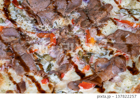 Savory pizza delight. Glistening teriyaki pizza featuring tender meat and smoky spices. Closeup of glazed teriyaki pizza highlighting charred cheese and spicy toppings Savory pizza delight. Glistening teriyaki pizza featuring tender meat and smoky spices. Closeup of glazed teriyaki pizza highlighting charred cheese and spicy toppings 137822257