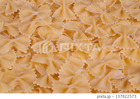 Highquality artisanal farfalle with visible semolina grains and textured edges. Luxurious chefstyle pasta featuring delicate ridges and rich texture emphasizing premium ingredients 137822573