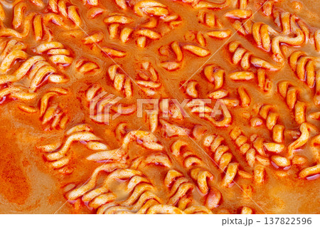 Spicy noodle appeal. Closeup shot emphasizing spicy noodles with seasonings and shine. Detailed view showcasing vibrant textures and toppings of spicy noodles for marketing Spicy noodle appeal. Closeup shot emphasizing spicy noodles with seasonings and shine. Detailed view showcasing vibrant textures and toppings of spicy noodles for marketing 137822596