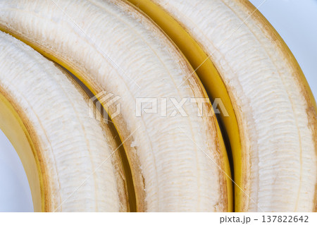 Ripe peeled bananas closeup arranged as snack portions, fresh moist surface, bright natural light, inviting warm palette, emphasizes nutrition, softness and biteready texture Ripe peeled bananas closeup arranged as snack portions, fresh moist surface, bright natural light, inviting warm palette, emphasizes nutrition, softness and biteready texture 137822642