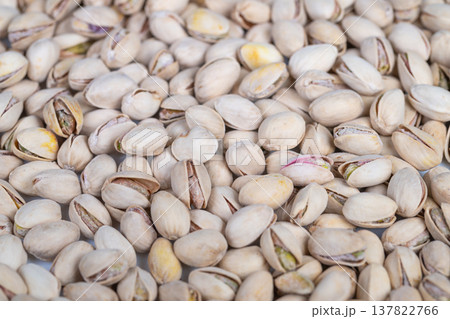 Compact display of shell surfaces. Closeup of pistachio shells with kernels. Intimate perspective of pistachio shells showcasing uneven surfaces and colors for design use Compact display of shell surfaces. Closeup of pistachio shells with kernels. Intimate perspective of pistachio shells showcasing uneven surfaces and colors for design use 137822766