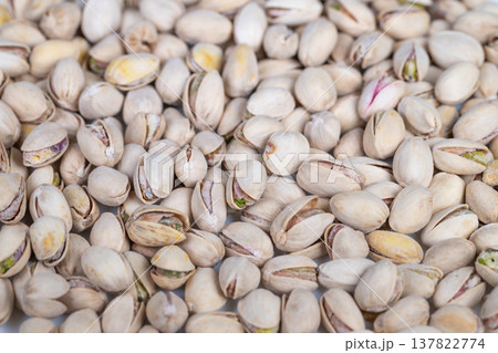 Pistachio shell pattern. Detailed pistachio shell background. Organic pistachio shell repetitive design image. High resolution flatlay of pistachio shells with neutral tones Pistachio shell pattern. Detailed pistachio shell background. Organic pistachio shell repetitive design image. High resolution flatlay of pistachio shells with neutral tones 137822774