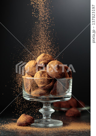 Chocolate truffles sprinkled with cocoa powder. 137823197