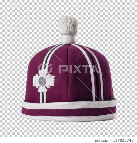 Purple ceremonial hat with white stripes and decorative emblem, featuring white pom pom on top, is displayed against plain background. design is traditional and ornate 137823743