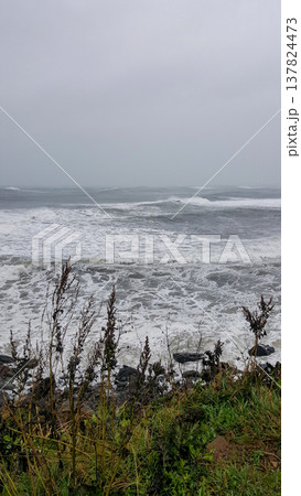 A view of a stormy sea from a rocky Kuril Islands coast 137824473