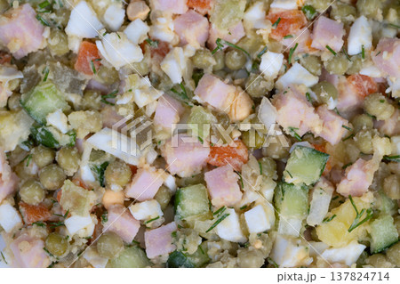 Family recipe memories. Traditional salad with nostalgic taste. Homestyle potato and ham salad with herbs. Comforting olive salad featuring tender potatoes and fresh herbs 137824714