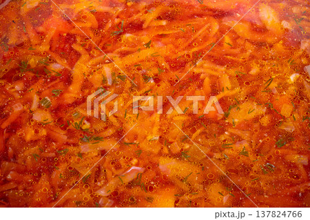 Hearty homemade vegetable stew. Traditional red soup with cabbage and potatoes. Comforting bowl of freshly prepared beet soup with vegetables and aromatic herbs Hearty homemade vegetable stew. Traditional red soup with cabbage and potatoes. Comforting bowl of freshly prepared beet soup with vegetables and aromatic herbs 137824766