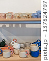 Handmade ceramic mugs and torso cups on display 137824797