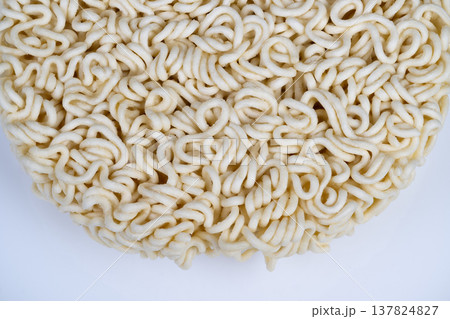 Large batch production demonstrates uniformity and dry texture quality. Inspection of instant noodles shows standardized shape and compressed dry texture quality indicators 137824827