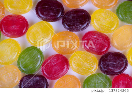 Multicolored candies creating mosaiclike surface, repeated glossy discs forming colorful carpet with strong contrast and rhythm, perfect for textile prints and desktop wallpapers Multicolored candies creating mosaiclike surface, repeated glossy discs forming colorful carpet with strong contrast and rhythm, perfect for textile prints and desktop wallpapers 137824866