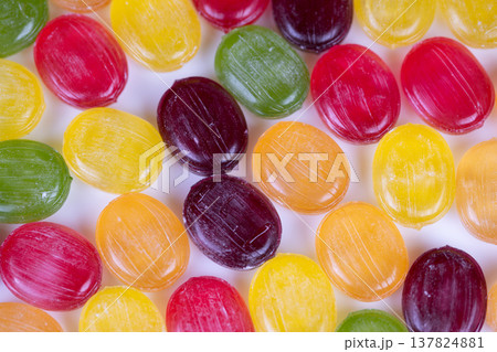 Brightly colored sweets with glossy surfaces and detailed textures. Detailed image of assorted brightly colored candies featuring shiny surfaces and crystallike sugar details 137824881