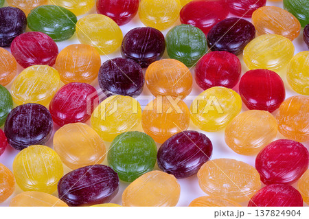 Bright multicolored candies in detailed arrangement. Dynamic macro shot showcasing glossy multicolored candies arranged in lively pattern suitable for confectionery branding Bright multicolored candies in detailed arrangement. Dynamic macro shot showcasing glossy multicolored candies arranged in lively pattern suitable for confectionery branding 137824904