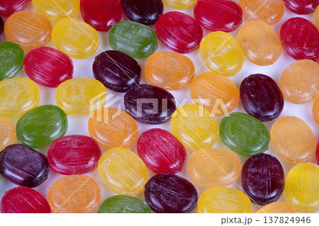 Retailready multicolored hard candies arranged for display on countertop, assorted colors creating eyecatching pattern, suitable for shop signage and product listings 137824946