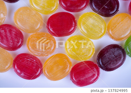 Bright candy photograph for display. Vivid multicolored confection product photo showcase. Cleanly styled candy image highlighting various vibrant pieces prominently 137824995