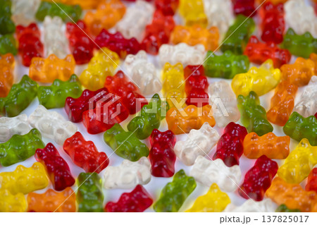Multicolored gummy bears evoking playful mood, saturated hues and joyful rhythm create uplifting visual, moodboard asset for wellness, social media and emotional branding projects 137825017
