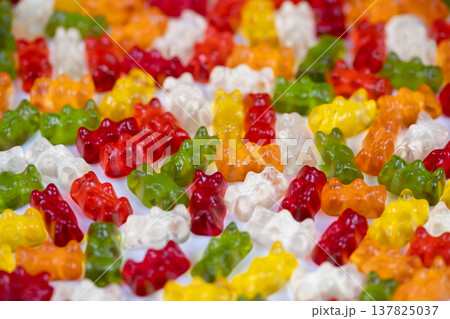 Festive assortment of gummy bears adds cheer to event displays. Playful multicolored gummy bears scattered to evoke happiness and festive spirit for celebrations 137825037