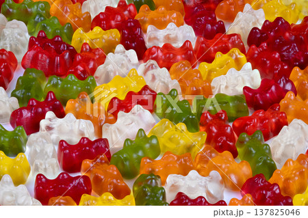 Dynamic rainbowthemed gummy bear background with glossy texture details. Energetic and vibrant candy bear pattern designed for seamless texture and visual appeal Dynamic rainbowthemed gummy bear background with glossy texture details. Energetic and vibrant candy bear pattern designed for seamless texture and visual appeal 137825046