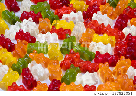 Close up of translucent multicolored gummy bears with bright studio highlights and glossy sheen, product photography vibe suited for advertising and confectionery branding 137825051