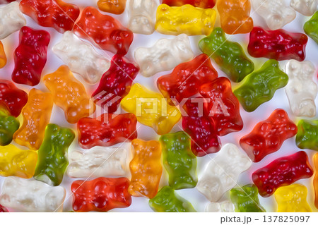 Gummy bears detailed. Closeup of glossy gummy bears. Magnified view reveals jellylike gummy surface. Transparent gummy bears with air bubbles and shiny highlights detailed 137825097