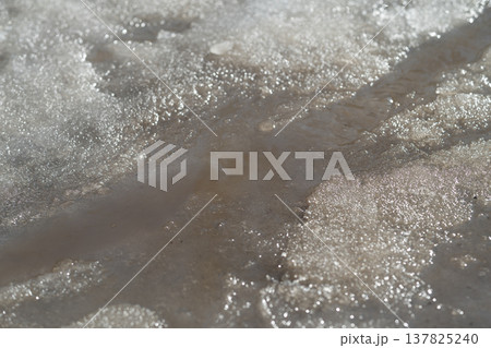 Seasonal snow transformation. Spring melt shapes nature. Melting terrain molds fresh spring waterways. Flowing melt transforms frozen landscape into vibrant seasonal scenery 137825240