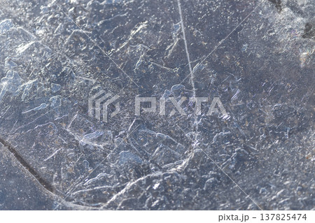 Glittering icy designs. Refined ice with detailed textures. Polished ice displaying complex maplike patterns. Sparkling frost with delicate scratches and subtle bubble formations Glittering icy designs. Refined ice with detailed textures. Polished ice displaying complex maplike patterns. Sparkling frost with delicate scratches and subtle bubble formations 137825474
