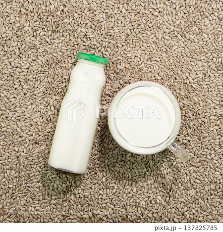 Sunflower Seed Milk In Bottle And Cup Surrounded By Raw Seeds Sunflower Seed Milk In Bottle And Cup Surrounded By Raw Seeds 137825785