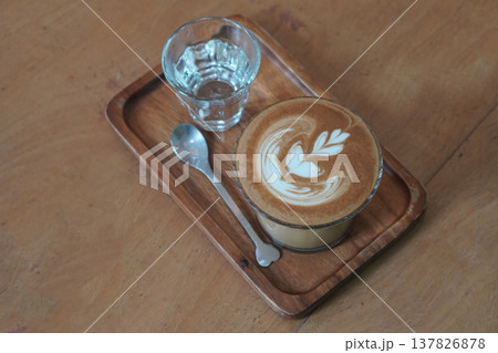 top view beautiful brown and white layer coffee in low glass on wooden tray, silver spoon and water in glass, brown wooden floor background, drink, cool, food, copy space top view beautiful brown and white layer coffee in low glass on wooden tray, silver spoon and water in glass, brown wooden floor background, drink, cool, food, copy space 137826878