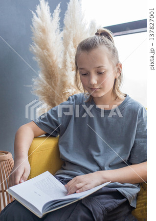 Cute child boy reading book at home Cute child boy reading book at home 137827001