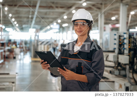 Professional occupation, standing. Woman is in the window making factory 137827033