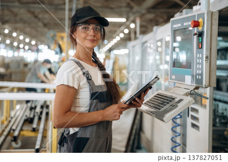 Machinery computer operator. Woman is in the window making factory 137827051