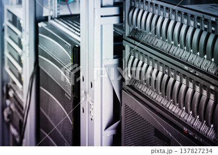 cluster of data storage SSD hard drives inside server rack 137827234