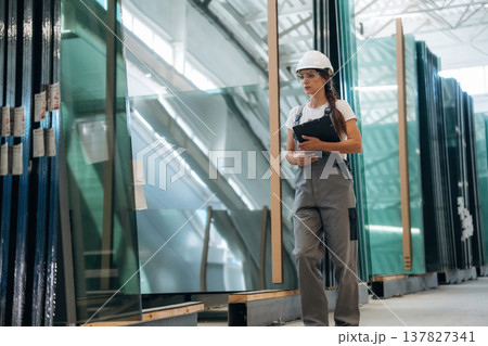Bunch of glass. Woman is in the window making factory Bunch of glass. Woman is in the window making factory 137827341