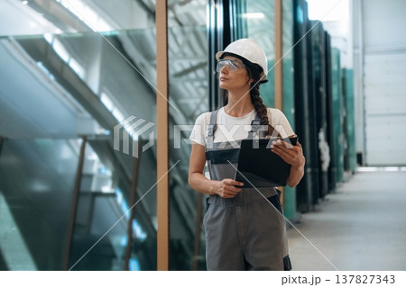 Bunch of glass. Woman is in the window making factory Bunch of glass. Woman is in the window making factory 137827343