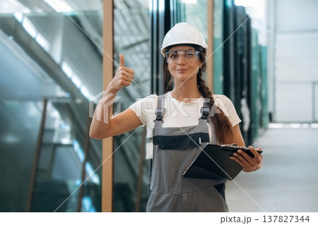 Bunch of glass. Woman is in the window making factory Bunch of glass. Woman is in the window making factory 137827344