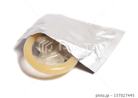 condom in foil packaging isolated on white background condom in foil packaging isolated on white background 137827445