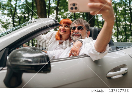 Time for a selfie. Senior couple driving convertible cabriolet car 137827728