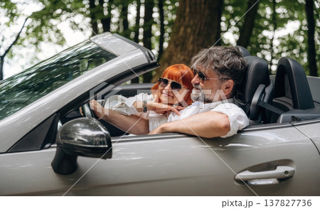Feeling good, going for vacation. Senior couple driving convertible cabriolet car 137827736