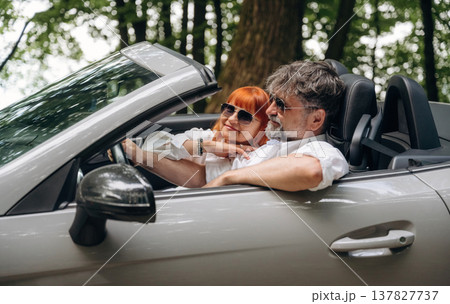 Feeling good, going for vacation. Senior couple driving convertible cabriolet car 137827737
