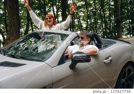 Feeling good, going for vacation. Senior couple driving convertible cabriolet car 137827738