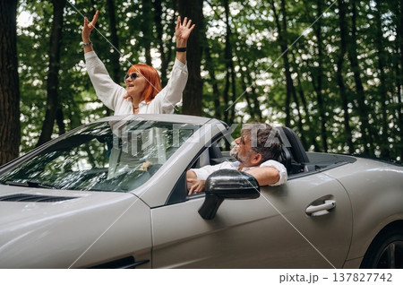 Vacation time. Senior couple driving convertible cabriolet car 137827742