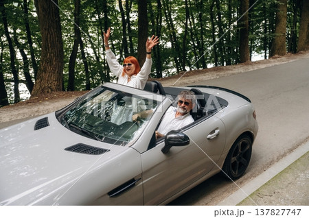 Vacation time. Senior couple driving convertible cabriolet car 137827747