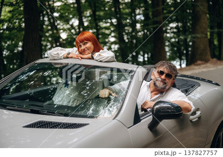 Senior couple driving convertible cabriolet car 137827757