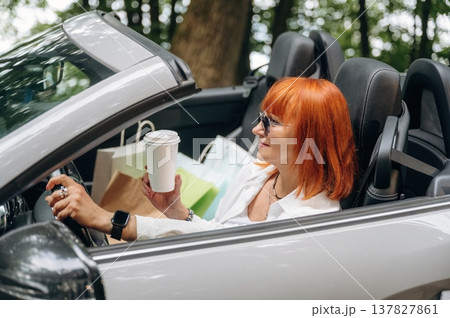 Having great time, in sunglasses. Side view of woman that is driving convertible cabriolet car Having great time, in sunglasses. Side view of woman that is driving convertible cabriolet car 137827861